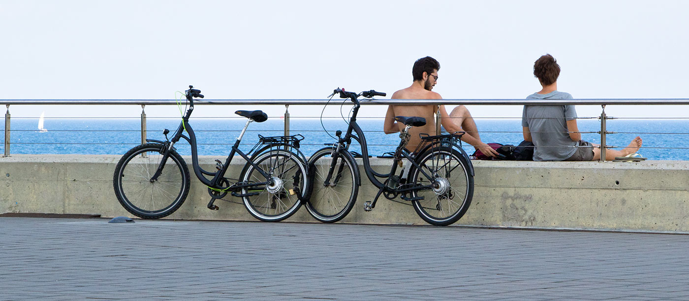 Two people enjoy the sun and the sea on a Barcelona summer day